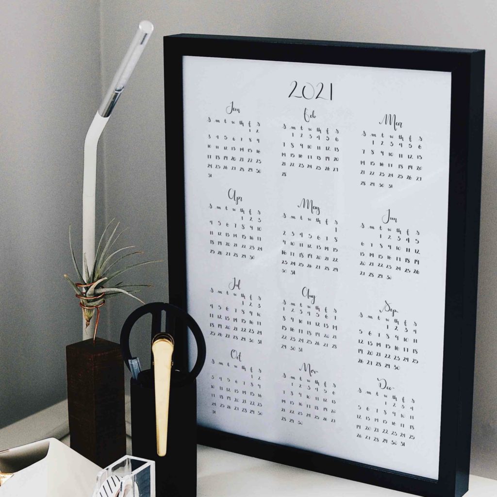 Photo of desk with picture frame of 12 month calendar