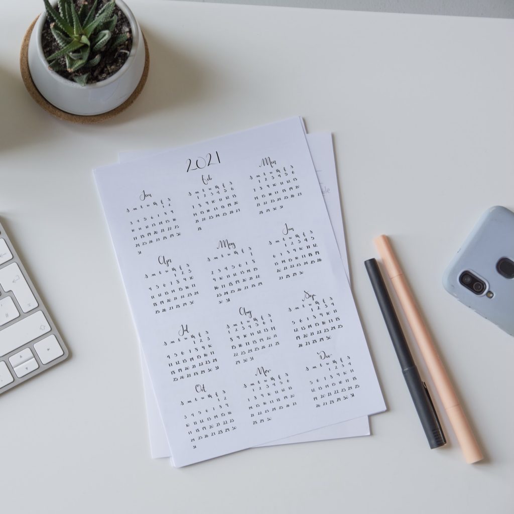 Photo of a desk with printed 12 month calendar on letter size paper